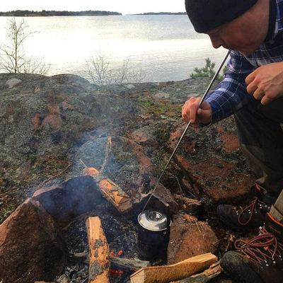 stoking the embers of a campfire is so easy with this fire blower tool